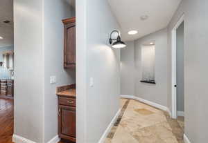 Hallway featuring baseboards and recessed lighting