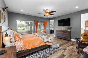 Bedroom featuring access to outside, baseboards, recessed lighting, wood finished floors, and a ceiling fan