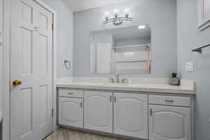 Bathroom featuring vanity and a shower
