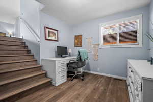 Office featuring dark wood-style floors and baseboards