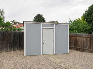 View of shed featuring a fenced backyard