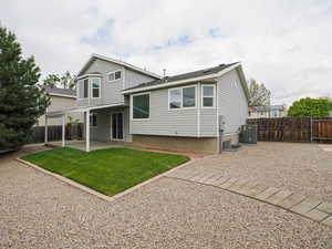 Back of house with a patio, central AC, and a gate