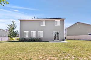 Back of house with a patio, solar panels, and stucco siding