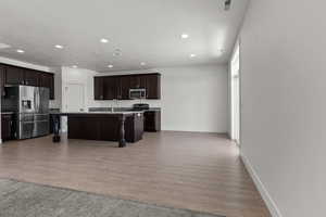 Kitchen with stainless steel appliances, recessed lighting, a sink, a kitchen bar, and a kitchen island with sink