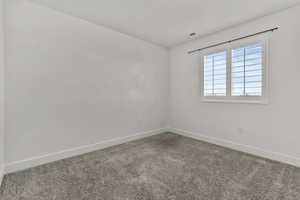 Unfurnished room with baseboards and carpet