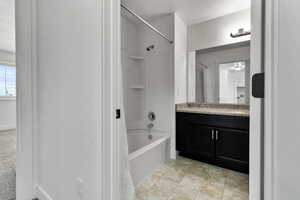 Full bath with shower / washtub combination and vanity