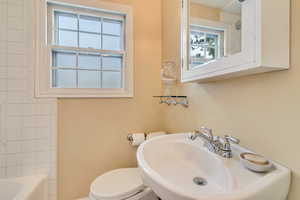 Full bath with a sink, toilet, and bathtub / shower combination
