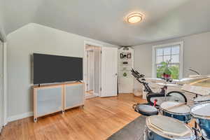 Exercise room featuring wood finished floors and baseboards