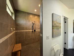 Full bath featuring a walk in shower, recessed lighting, tile patterned flooring, and baseboards