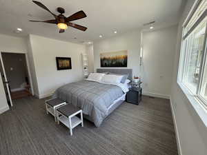 Bedroom with carpet, recessed lighting, baseboards, a textured ceiling, and ceiling fan