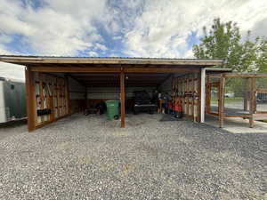 View of parking featuring an outbuilding