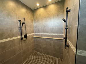Bathroom with a tile shower and recessed lighting