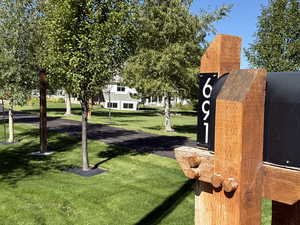 View of home's community with a yard