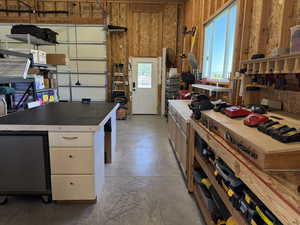 Kitchen featuring concrete flooring and white cabinetry