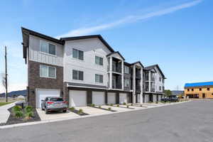 View of building exterior featuring driveway and a garage