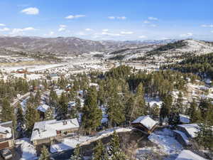 Snowy aerial view featuring a mountain view
