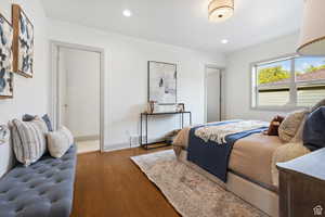 Bedroom with wood finished floors, recessed lighting, and baseboards