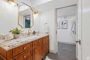 Full bathroom with vanity and tile patterned floors