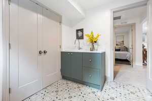 Bathroom featuring tile patterned floors, vanity, and ensuite bathroom