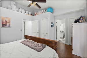 Bedroom featuring vaulted ceiling, wood-type flooring, a ceiling fan, and ensuite bathroom