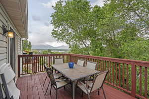 Wooden terrace with outdoor dining area and a mountain view