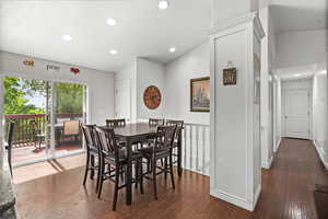 Dining room featuring hardwood / wood-style floors, recessed lighting, vaulted ceiling, and baseboards