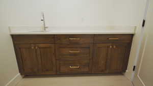 Bathroom with a sink and baseboards