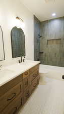 Full bath featuring double vanity, toilet, bathing tub / shower combination, and recessed lighting