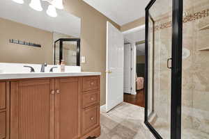 Full bath featuring a shower stall and vanity