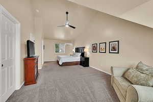 Carpeted bedroom with baseboards, an AC wall unit, high vaulted ceiling, and ceiling fan