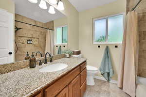 Full bathroom featuring healthy amount of natural light, vanity, baseboards, and toilet