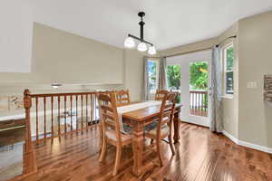 Dining space featuring wood finished floors, plenty of natural light, and baseboards