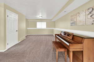 Sitting room featuring carpet and baseboards
