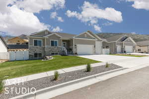 Craftsman-style home featuring a gate, driveway, an attached garage, and a mountain view