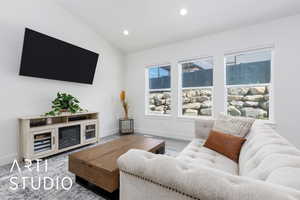 Living room with vaulted ceiling, recessed lighting, wood finished floors, and baseboards