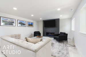 Living area featuring recessed lighting, a premium fireplace, and baseboards