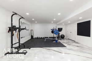 Exercise area with recessed lighting and baseboards