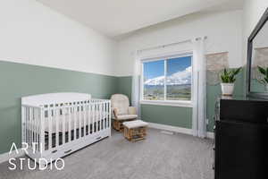 Bedroom featuring carpet floors, a nursery area, and baseboards