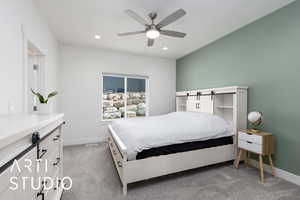 Carpeted bedroom featuring baseboards, recessed lighting, a ceiling fan, and a barn door
