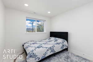 Carpeted bedroom featuring baseboards and recessed lighting