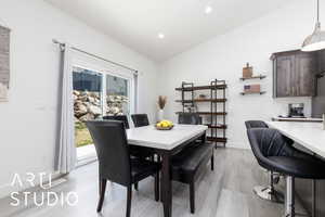 Dining area with light wood-type flooring, recessed lighting, baseboards, and lofted ceiling