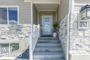 Entrance to property featuring stone siding