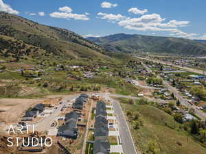Aerial view of property's location with a mountain backdrop and nearby suburban area