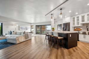 Kitchen with stainless steel fridge, a healthy amount of natural light, open floor plan, and recessed lighting