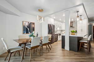 Dining area featuring light wood-style flooring and recessed lighting