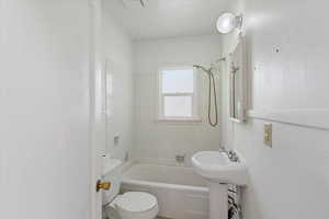 Full bathroom with toilet and tub / shower combination