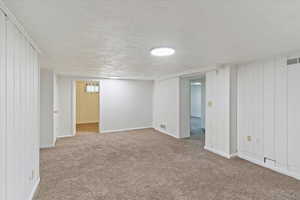 Basement family room featuring carpet floors and baseboards