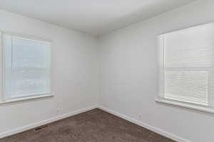 Bedroom with carpet, baseboards, and plenty of natural light