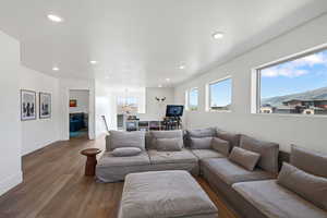 Living area featuring wood finished floors, recessed lighting, and baseboards