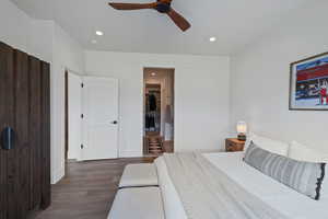 Bedroom featuring wood finished floors, recessed lighting, baseboards, and a ceiling fan